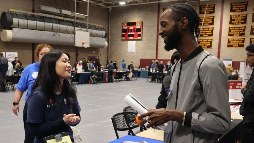 student talking to employer at career fair